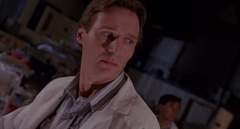 Movie still from “Darkman” (1990), directed by Sam Raimi – A person wearing a white lab coat; Close Up shot, Low angle