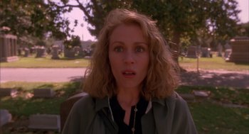 Movie still from “Darkman” (1990), directed by Sam Raimi – A person with curly blonde hair; Close Up shot, Over the shoulder angle