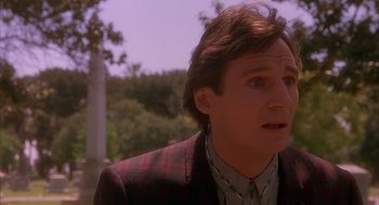 Movie still from “Darkman” (1990), directed by Sam Raimi – A person wearing a suit and tie; Close Up shot, Over the shoulder angle