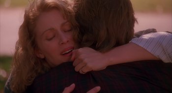 Movie still from “Darkman” (1990), directed by Sam Raimi – A woman is hugging another woman who is holding her head; Close Up shot, Over the shoulder angle