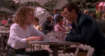Movie still from “Darkman” (1990), directed by Sam Raimi – A man and a woman are sitting at a table; Medium shot, Over the shoulder angle