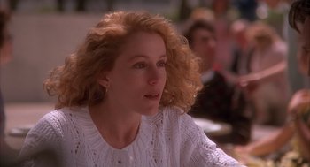 Movie still from “Darkman” (1990), directed by Sam Raimi – A person sitting in a room; Close Up shot, Over the shoulder angle