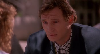 Movie still from “Darkman” (1990), directed by Sam Raimi – A person wearing a suit and tie; Close Up shot, Over the shoulder angle