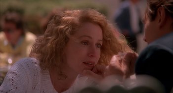 Movie still from “Darkman” (1990), directed by Sam Raimi – A person with curly blonde hair; Close Up shot, Over the shoulder angle