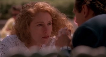 Movie still from “Darkman” (1990), directed by Sam Raimi – A person with curly red hair; Close Up shot, Over the shoulder angle