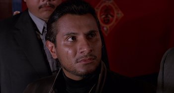 Movie still from “Darkman” (1990), directed by Sam Raimi – A person wearing a suit and tie; Close Up shot, Low angle