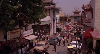 Movie still from “Darkman” (1990), directed by Sam Raimi – A busy street with a lot of people walking around; Extreme Wide shot, High angle