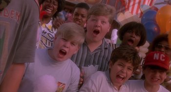 Movie still from “Darkman” (1990), directed by Sam Raimi – A group of young people standing next to each other; Close Up shot, Low angle