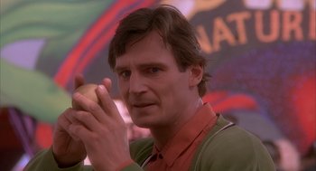 Movie still from “Darkman” (1990), directed by Sam Raimi – A person holding a piece of food; Close Up shot, Low angle