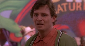 Movie still from “Darkman” (1990), directed by Sam Raimi – A person wearing a red shirt; Close Up shot, Over the shoulder angle