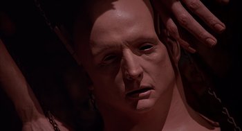 Movie still from “Darkman” (1990), directed by Sam Raimi – The face of a man in a mask; Close Up shot, High angle