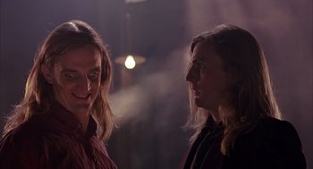 Movie still from “Darkman” (1990), directed by Sam Raimi – Two people are talking in a dark room; Close Up shot, Low angle