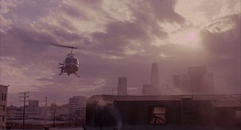 Movie still from “Darkman” (1990), directed by Sam Raimi – A helicopter is flying over a building in a city; Extreme Wide shot, Low angle
