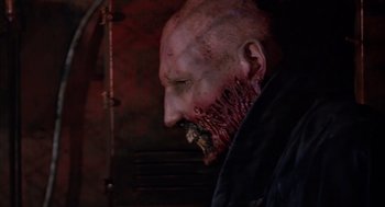 A person's face covered in fake blood