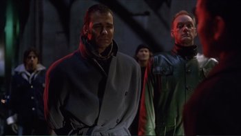 Movie still from “Darkman III: Die Darkman Die” (1996), directed by Bradford May – A group of men standing next to each other; Medium shot, Low angle