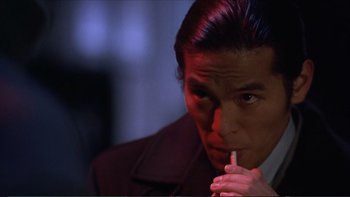 Movie still from “Darkman III: Die Darkman Die” (1996), directed by Bradford May – A person smoking a cigarette; Close Up shot, Low angle