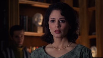 Movie still from “Darkman III: Die Darkman Die” (1996), directed by Bradford May – A person wearing a necklace; Close Up shot, Over the shoulder angle