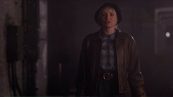 Movie still from “Darkman III: Die Darkman Die” (1996), directed by Bradford May – A woman wearing a hat and a leather jacket; Medium shot, Low angle