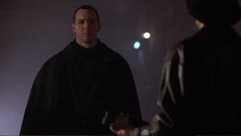 Movie still from “Darkman III: Die Darkman Die” (1996), directed by Bradford May – A man standing in front of a mirror in a dark room; Close Up shot, Low angle