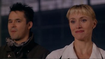 Movie still from “Darkman III: Die Darkman Die” (1996), directed by Bradford May – A woman and a man standing next to each other; Close Up shot, Over the shoulder angle