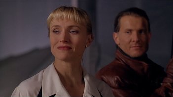 Movie still from “Darkman III: Die Darkman Die” (1996), directed by Bradford May – A person wearing a suit and tie; Close Up shot, Over the shoulder angle