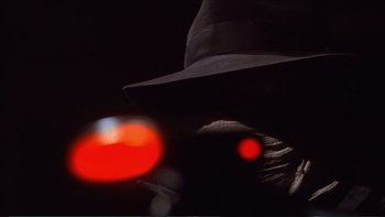 Movie still from “Darkman III: Die Darkman Die” (1996), directed by Bradford May – A person wearing a hat and a red light; Extreme Close Up shot, Low angle