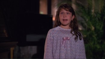 Movie still from “Darkman III: Die Darkman Die” (1996), directed by Bradford May – A young girl wearing a nightgown standing in front of a fireplace; Close Up shot, High angle