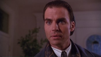 Movie still from “Darkman III: Die Darkman Die” (1996), directed by Bradford May – A man that is wearing a suit and tie; Close Up shot, Low angle