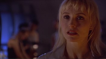 Movie still from “Darkman III: Die Darkman Die” (1996), directed by Bradford May – A person wearing a white shirt; Close Up shot, Over the shoulder angle