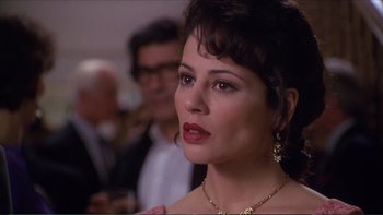 Movie still from “Darkman III: Die Darkman Die” (1996), directed by Bradford May – A person wearing a necklace; Close Up shot, Over the shoulder angle