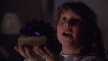 Movie still from “Darkman III: Die Darkman Die” (1996), directed by Bradford May – A little girl holding a piece of cake in her hands; Close Up shot, High angle