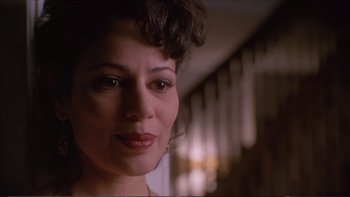 Movie still from “Darkman III: Die Darkman Die” (1996), directed by Bradford May – A woman's face in a dark room; Close Up shot, Low angle