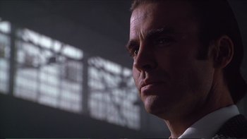 Movie still from “Darkman III: Die Darkman Die” (1996), directed by Bradford May – A man's face in front of a window; Close Up shot, Low angle