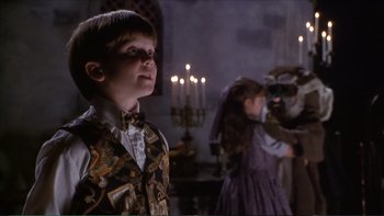 Movie still from “Darkman III: Die Darkman Die” (1996), directed by Bradford May – A boy and a girl dressed up in costumes; Medium shot, Over the shoulder angle