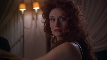 Movie still from “Darkman III: Die Darkman Die” (1996), directed by Bradford May – A person with long curly red hair; Close Up shot, Over the shoulder angle