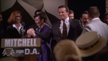 Movie still from “Darkman III: Die Darkman Die” (1996), directed by Bradford May – A group of people standing next to each other in a room; Medium shot, High angle