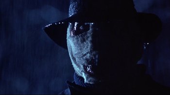 Movie still from “Darkman II: The Return of Durant” (1995), directed by Bradford May – A person wearing a mask and a hat; Close Up shot, Low angle
