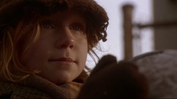 Movie still from “Darkman II: The Return of Durant” (1995), directed by Bradford May – A person wearing a hat and a scarf; Close Up shot, Low angle
