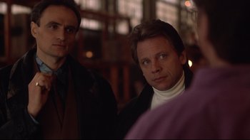 Movie still from “Darkman II: The Return of Durant” (1995), directed by Bradford May – A man in a white shirt and a man in a black jacket; Close Up shot, Over the shoulder angle