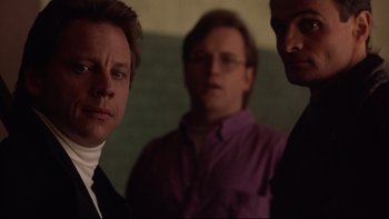 Movie still from “Darkman II: The Return of Durant” (1995), directed by Bradford May – A group of men standing next to each other in a room; Close Up shot, Low angle