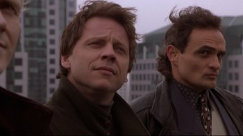 Movie still from “Darkman II: The Return of Durant” (1995), directed by Bradford May – A man in a brown jacket and a man in a black jacket; Close Up shot, Low angle