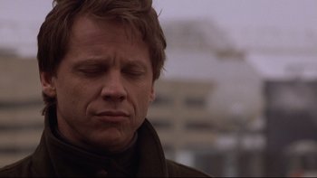 Movie still from “Darkman II: The Return of Durant” (1995), directed by Bradford May – A person with his eyes closed; Close Up shot, Low angle