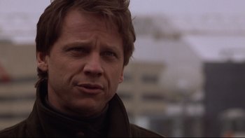 Movie still from “Darkman II: The Return of Durant” (1995), directed by Bradford May – A person wearing a jacket; Close Up shot, Over the shoulder angle