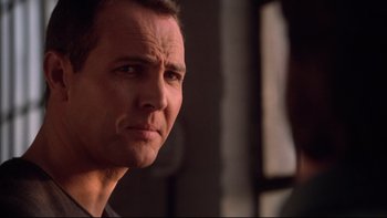 Movie still from “Darkman II: The Return of Durant” (1995), directed by Bradford May – A man's face in front of a window; Close Up shot, Low angle