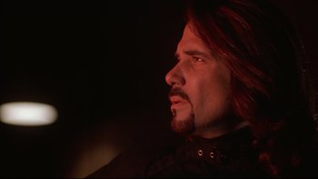 Movie still from “Darkman II: The Return of Durant” (1995), directed by Bradford May – A person with long red hair and a beard; Close Up shot, Low angle
