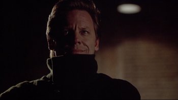 Movie still from “Darkman II: The Return of Durant” (1995), directed by Bradford May – A person wearing a black jacket; Close Up shot, Low angle