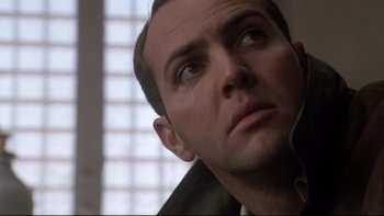 Movie still from “Darkman II: The Return of Durant” (1995), directed by Bradford May – A man's face looking upward; Close Up shot, Low angle
