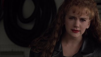 Movie still from “Darkman II: The Return of Durant” (1995), directed by Bradford May – A person wearing a leather jacket; Close Up shot, Over the shoulder angle