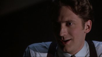 Movie still from “Darkman II: The Return of Durant” (1995), directed by Bradford May – A person wearing a suit and tie; Close Up shot, Low angle