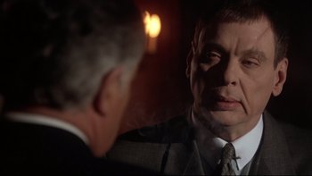 Movie still from “Darkman II: The Return of Durant” (1995), directed by Bradford May – A man looking at his reflection in a mirror; Close Up shot, Over the shoulder angle